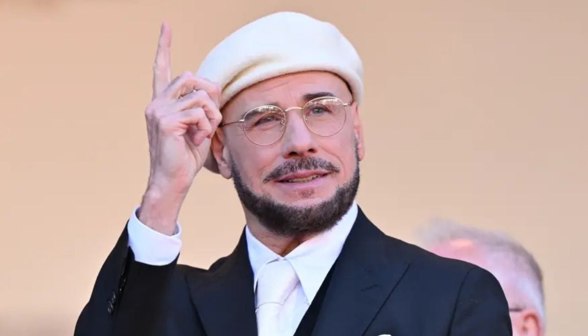 John Travolta explains his beret looks at Cannes as a homage to old-school directors