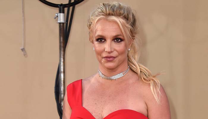 Britney Spears embraces holiday cheer in red cutout dress