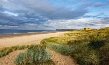 Police rush to scene after woman found dead on UK beach 