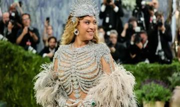 Beyoncé stuns at 2026 Met Gala in sparkling skeleton-inspired nude gown with dramatic feathered cape