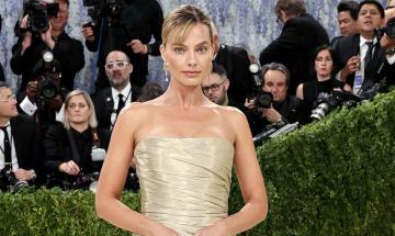Margot Robbie returns to Met Gala in custom gold Chanel gown