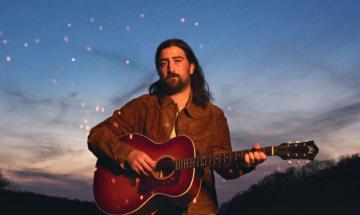 Noah Kahan reveals heartbreaking story behind fire tower tattoo