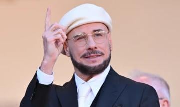 John Travolta explains his beret looks at Cannes as a homage to old-school directors